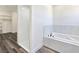 Bright bathroom features a large soaking tub, seamless glass shower, and access to a spacious walk-in closet at 1351 Huckleberry St, Pahrump, NV 89048