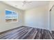 Clean, minimalist bedroom with wood-style flooring and natural light from the window at 1351 Huckleberry St, Pahrump, NV 89048
