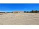 Exterior side view of the house showcasing its expansive lot and charming facade at 1351 Huckleberry St, Pahrump, NV 89048