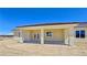 Exterior view of the home, showing the covered patio and large yard at 1351 Huckleberry St, Pahrump, NV 89048