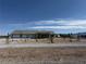 Charming single-story home with three-car garage and desert landscaping at 1351 Huckleberry St, Pahrump, NV 89048