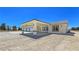 Spacious three-car garage attached to a tan home with inviting covered entrance at 1351 Huckleberry St, Pahrump, NV 89048