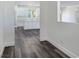 Hallway view of a bright kitchen featuring white cabinets, marble countertops and luxury vinyl plank flooring at 1351 Huckleberry St, Pahrump, NV 89048