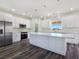 Bright kitchen with stainless steel appliances, a large island, white cabinets and pendant lighting at 1351 Huckleberry St, Pahrump, NV 89048