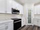 Bright kitchen with stainless steel appliances, white cabinets, and a pantry for ample storage at 1351 Huckleberry St, Pahrump, NV 89048