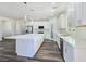 Bright kitchen featuring white cabinets, a center island, and stainless steel appliances at 1351 Huckleberry St, Pahrump, NV 89048