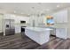 Modern kitchen featuring stainless steel appliances, an island, white cabinets and marble countertops at 1351 Huckleberry St, Pahrump, NV 89048