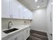 Bright laundry room featuring white cabinets and countertops at 1351 Huckleberry St, Pahrump, NV 89048