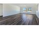 Spacious living room featuring LVP flooring and a wall of windows offering an inviting view at 1351 Huckleberry St, Pahrump, NV 89048
