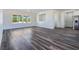 Open-concept living area with luxury vinyl plank flooring and expansive windows offering ample natural light at 1351 Huckleberry St, Pahrump, NV 89048