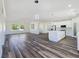 Bright, open floor plan with a kitchen, living room, and wood floors throughout the home at 1351 Huckleberry St, Pahrump, NV 89048