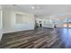 Open-concept living space with luxury vinyl plank flooring connecting living room and kitchen at 1351 Huckleberry St, Pahrump, NV 89048