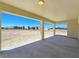 Covered patio with concrete floor, overlooking the spacious backyard and distant mountain views at 1351 Huckleberry St, Pahrump, NV 89048