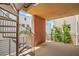 Outdoor balcony with a unique spiral staircase and views of surrounding buildings and landscaping at 1448 Canyon Ledge Ct, Las Vegas, NV 89117