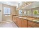 Bright bathroom features a double sink vanity, granite countertop, and ample natural light at 1448 Canyon Ledge Ct, Las Vegas, NV 89117