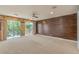Spacious primary bedroom with wood paneling and sliding door access to the outdoor balcony at 1448 Canyon Ledge Ct, Las Vegas, NV 89117