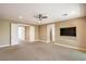 Spacious bedroom featuring neutral carpet, ceiling fan, and a doorway to another room at 1448 Canyon Ledge Ct, Las Vegas, NV 89117