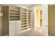 Spacious closet with custom built-ins, shelving, and drawers, leading to another closet at 1448 Canyon Ledge Ct, Las Vegas, NV 89117