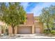Contemporary two-story home with a two-car garage and desert landscaping at 1448 Canyon Ledge Ct, Las Vegas, NV 89117