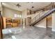 Open-concept living space with modern staircase, kitchen and abundant natural light at 1448 Canyon Ledge Ct, Las Vegas, NV 89117
