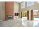 Spacious living room featuring high ceilings, a modern fireplace, and large windows at 1448 Canyon Ledge Ct, Las Vegas, NV 89117