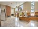 Bright open-concept living area with a fireplace, kitchen, and large windows at 1448 Canyon Ledge Ct, Las Vegas, NV 89117