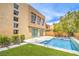 Backyard oasis with a pool, manicured lawn, and desert landscaping at 1448 Canyon Ledge Ct, Las Vegas, NV 89117