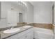 Bright bathroom featuring double sinks with granite counters and a bathtub at 1505 Blackcombe St # 202, Las Vegas, NV 89128