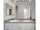 Bright bathroom featuring double sinks with granite counters and a large mirror at 1505 Blackcombe St # 202, Las Vegas, NV 89128