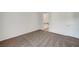 Bright bedroom with neutral carpet and attached bathroom featuring modern white door at 1505 Blackcombe St # 202, Las Vegas, NV 89128