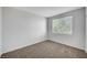 Bright bedroom with neutral carpet and a large window offering lots of light at 1505 Blackcombe St # 202, Las Vegas, NV 89128