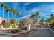 Community entrance provides secure access and is lined with tall palm trees at 1505 Blackcombe St # 202, Las Vegas, NV 89128