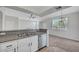 Bright kitchen featuring stainless steel appliances, granite countertops, a double sink, and a view into the living area at 1505 Blackcombe St # 202, Las Vegas, NV 89128