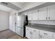 Bright kitchen showcasing white cabinets, granite countertops, stainless steel appliances, and natural light from a nearby window at 1505 Blackcombe St # 202, Las Vegas, NV 89128