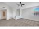Bright living room with neutral walls, plush carpeting, ceiling fan, and natural light from a window at 1505 Blackcombe St # 202, Las Vegas, NV 89128