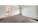 Spacious living room with neutral carpet and an open layout that connects to an en-suite bathroom at 1505 Blackcombe St # 202, Las Vegas, NV 89128