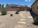Gravel backyard with desert landscaping and solar panels on the roof of the house at 152 Lotus Vale Ave, Las Vegas, NV 89123