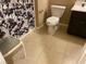 Well-lit bathroom featuring tile floors and a standard toilet and sink at 152 Lotus Vale Ave, Las Vegas, NV 89123