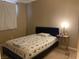 Simple bedroom with neutral walls, a queen bed, and a small bedside table at 152 Lotus Vale Ave, Las Vegas, NV 89123