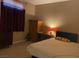 Comfortable bedroom with neutral walls and accent lighting at 152 Lotus Vale Ave, Las Vegas, NV 89123