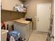 Laundry room featuring a washer and dryer, shelving, and a back door at 152 Lotus Vale Ave, Las Vegas, NV 89123