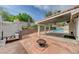 Charming backyard featuring a pool, covered patio, and fire pit, ideal for outdoor gatherings at 1523 Silver Point Ave, Las Vegas, NV 89123