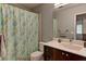 Bathroom with gray walls, dark vanity, and patterned shower curtain at 1523 Silver Point Ave, Las Vegas, NV 89123