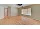 Bright bedroom featuring wood floors, a ceiling fan, and a sunlit window providing a relaxing ambiance at 1523 Silver Point Ave, Las Vegas, NV 89123