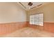 Comfortable bedroom with unique wood paneling, tiled floors, and a ceiling fan fixture at 1523 Silver Point Ave, Las Vegas, NV 89123