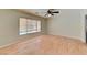Bedroom featuring hardwood floors, a ceiling fan, and large windows at 1523 Silver Point Ave, Las Vegas, NV 89123