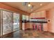 Modern kitchen featuring slate tile floors, granite counters, and a sliding glass door to the backyard at 1523 Silver Point Ave, Las Vegas, NV 89123