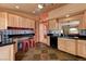 Cozy kitchen features tile floors, light wood cabinets, black countertops, and a decorative backsplash at 1523 Silver Point Ave, Las Vegas, NV 89123