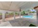 Covered patio with a pool view, stone columns, and ample space for outdoor relaxation at 1523 Silver Point Ave, Las Vegas, NV 89123