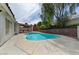 Backyard pool surrounded by trees and retaining walls creating a private outdoor oasis at 1523 Silver Point Ave, Las Vegas, NV 89123